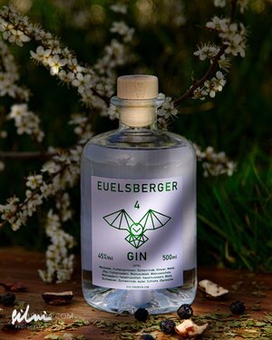500ml Euelsberger Gin bottle with 45% alcohol, wooden cork, green bat logo, flowers background
