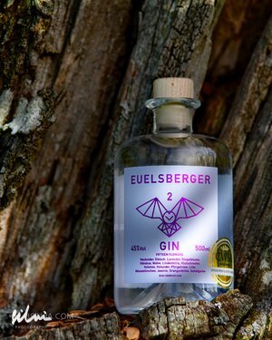 Bottle of Euelsberger 2 Gin 500ml with 45% alcohol against textured tree bark background.