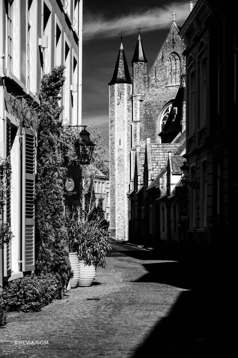 Bruges church towers infrared narrow street perspective